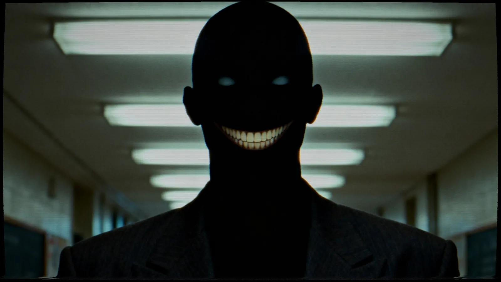 The proctor, a grinning silhouette with glowing eyes